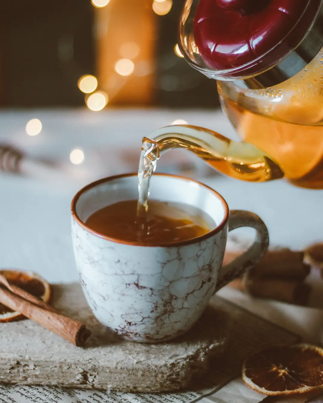 “Warm honey cinnamon tea with a cinnamon stick and star anise in a cozy winter setting.”